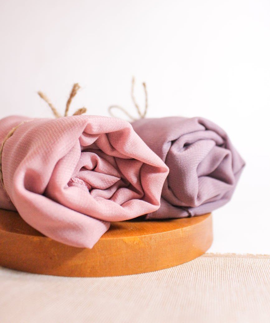 Soft pastel Pashmina shawls folded and displayed — illustrating colour range and quality finish
